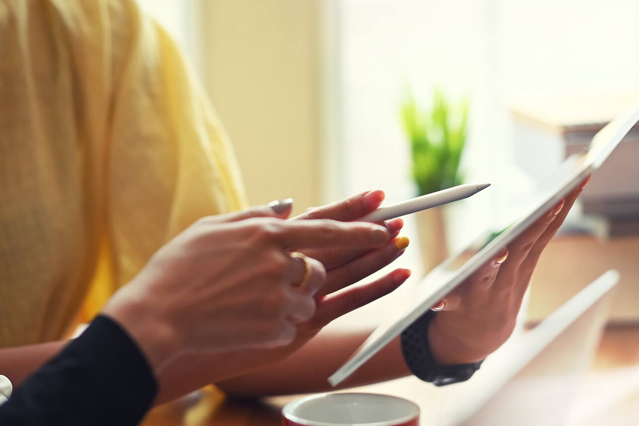 Closeup of Women's Hands Pointing to a Tablet